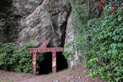 Flanked by wooden carvings and kawakawa bushes, Muriwai's Cave in Whakatāne once extended 122 metres into the hillside and is one of the region's most sacred and historically significant sites. Photo / Outdoor Kid