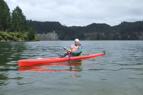 Parent and child kayaking on Lake Matahina