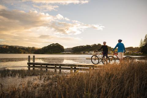 Cycling couple on trail on jetty