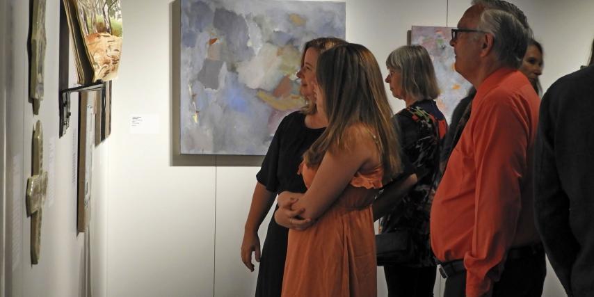 People enjoying artworks at the exhibition