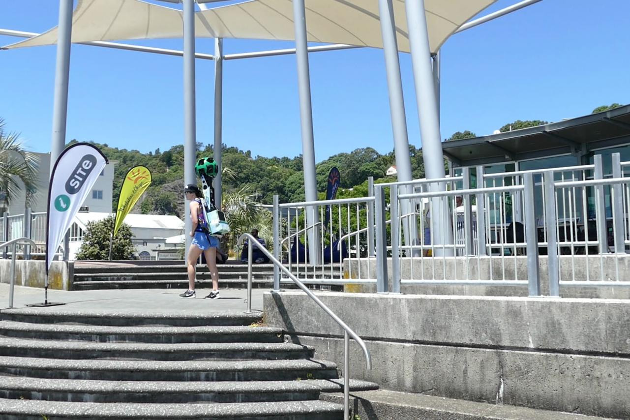 Trekker Walking past Whakatane i-SITE