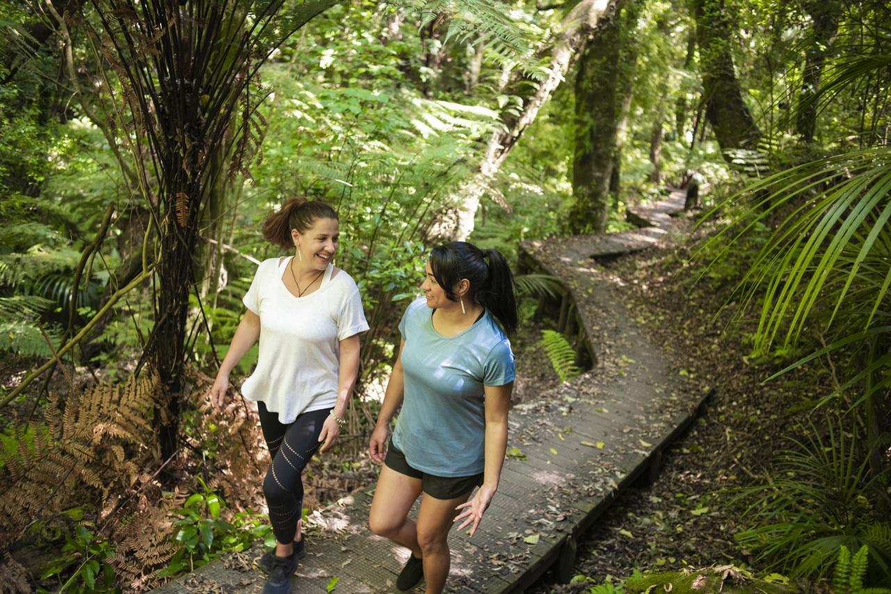 Friends walking in bush section of trail