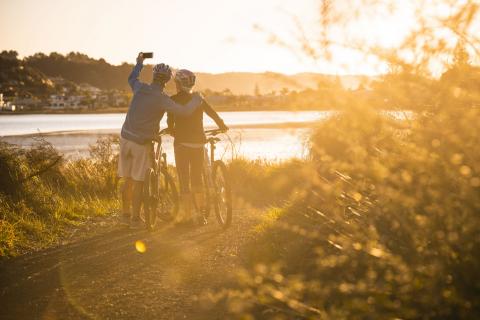 Cycling couple on trail taking a selfie