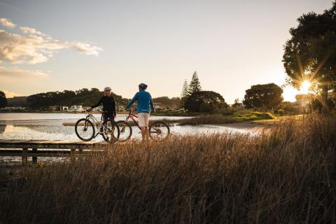 Cycling couple on trail on jetty