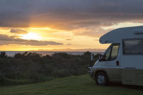 Campervan parked, with sunrise in background