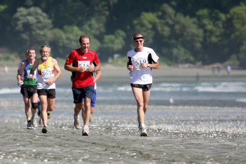 Competitors running down the beach