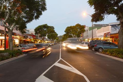 Cars driving down The Strand at dusk