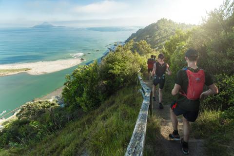 Toi's Challenge runners with coastal view